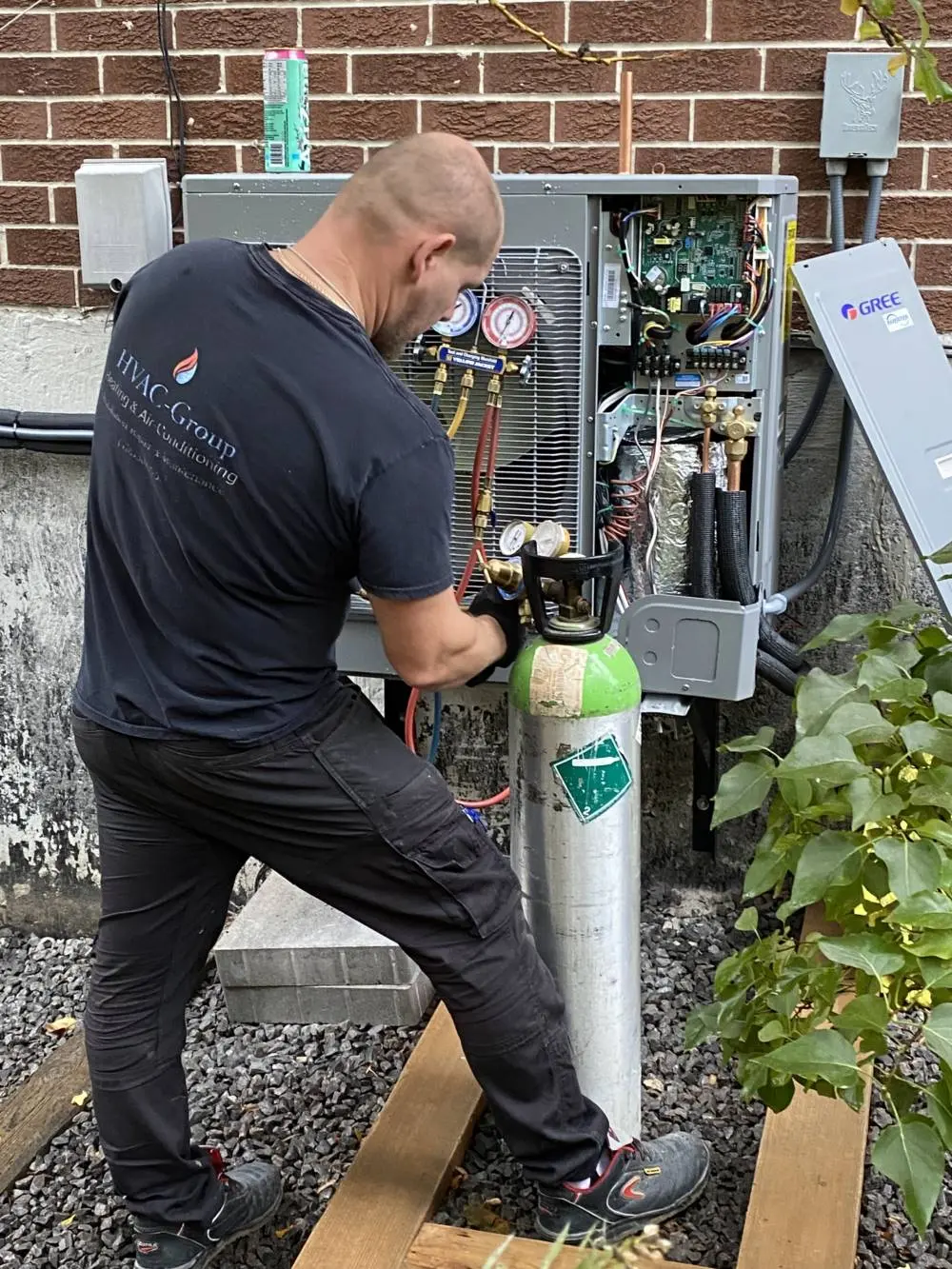 Professional HVAC technician refilling a heat pump system with refrigerant for optimal efficiency