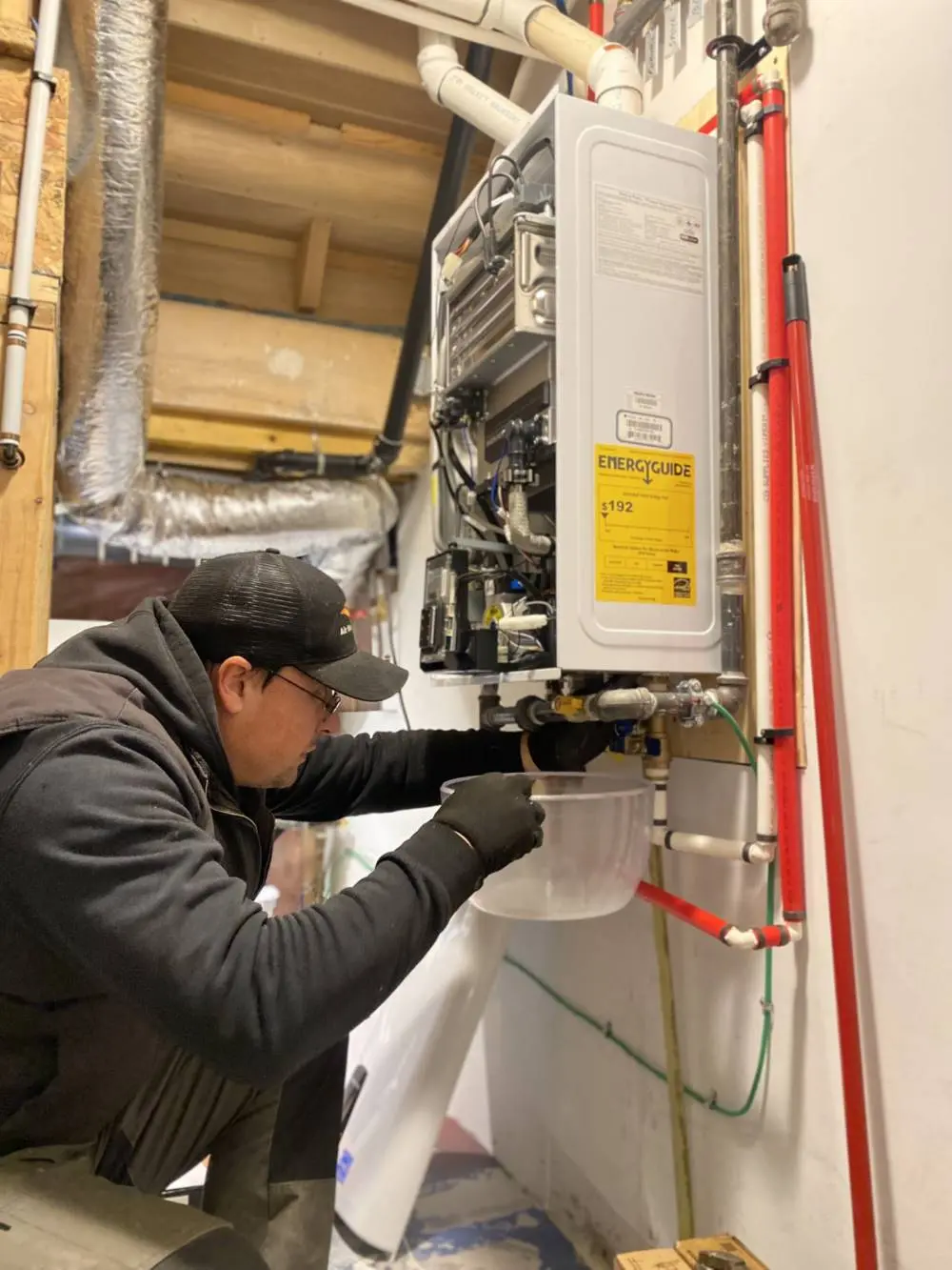 HVAC technician servicing a tankless water heater for optimal performance and efficiency
