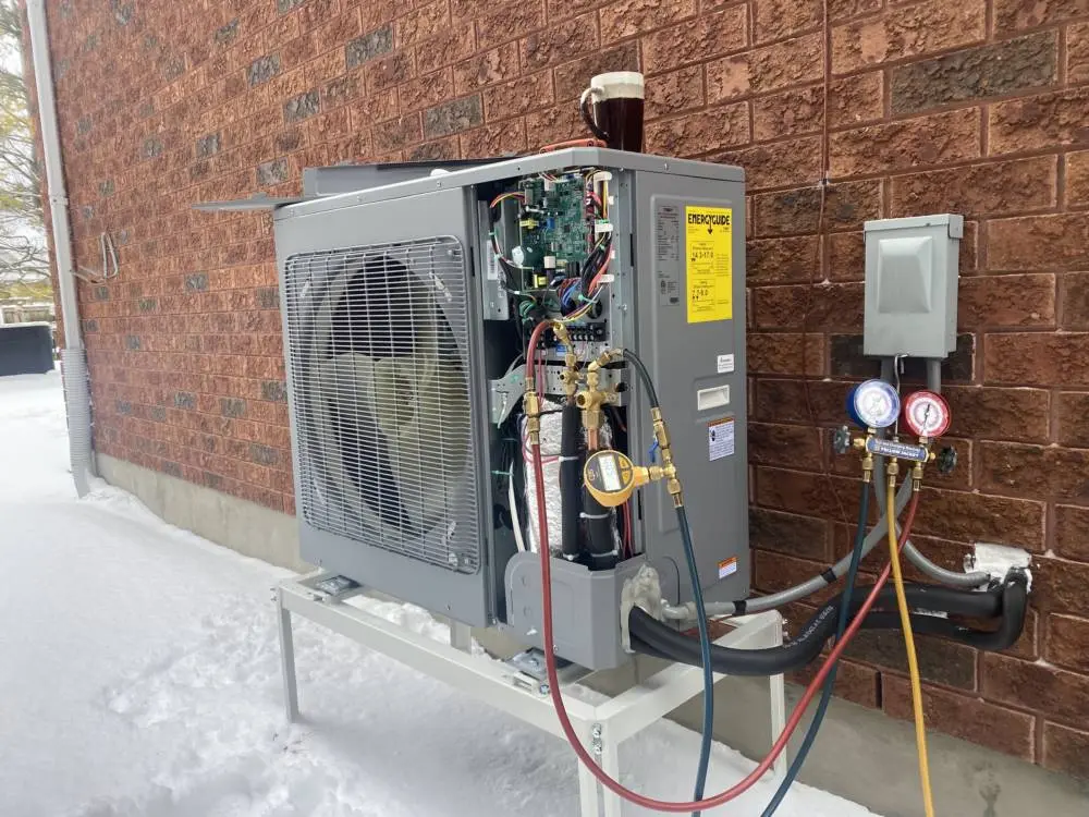 Heat pump system in winter with refrigerant gauges for efficient home heating and cooling