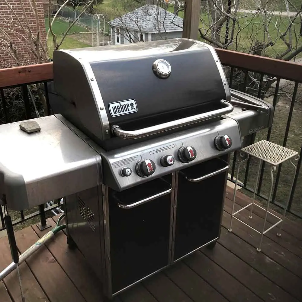 Natural gas Weber BBQ setup on wooden deck, connected for outdoor grilling