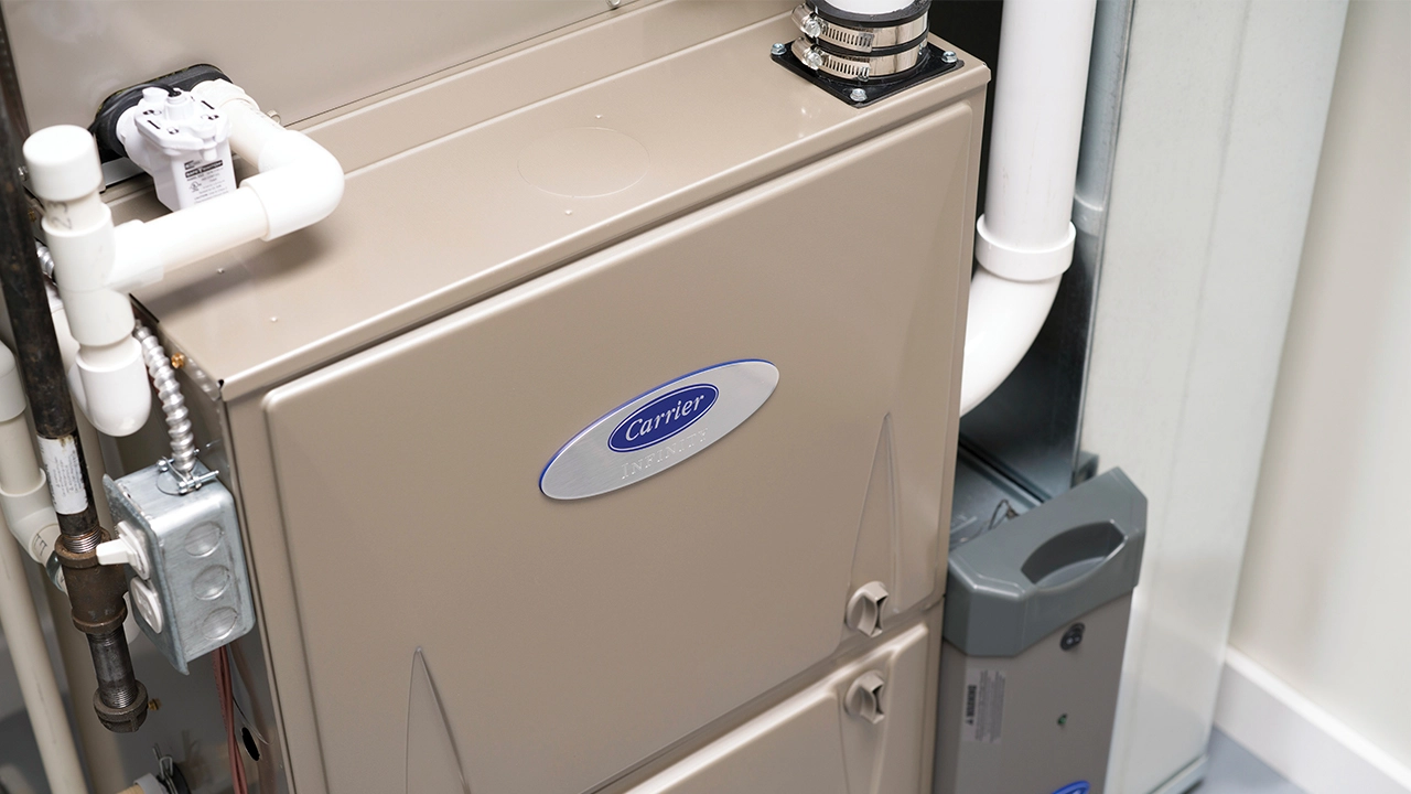 Carrier gas furnace installed with PVC flue piping and humidifier unit in a Mississauga utility room