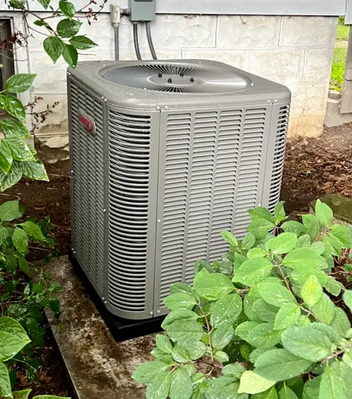 Lennox central air conditioner condenser installed on a concrete pad beside a residential home Mississauga