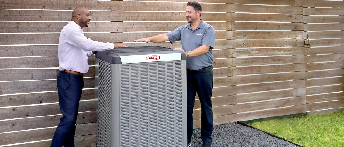 Lennox technician presenting a newly installed AC condenser unit to a satisfied homeowner in Mississauga