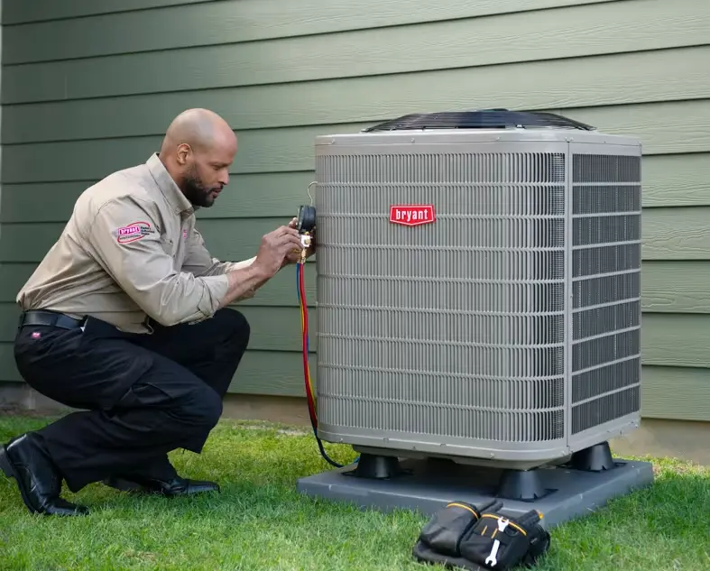 Technician connecting refrigerant gauge to a Bryant central air conditioner condenser in Mississauga