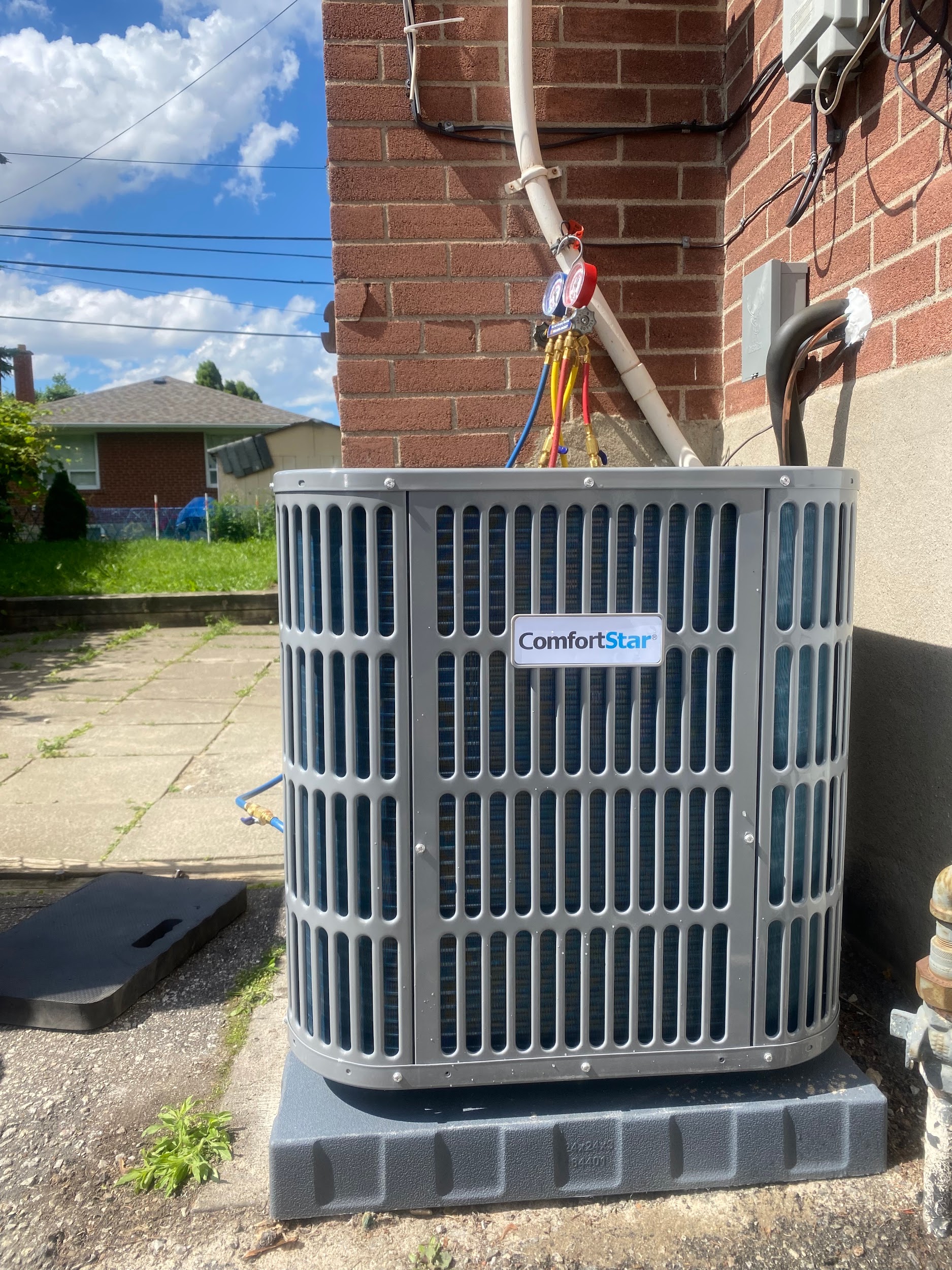 ComfortStar central air conditioner condenser with manifold gauges attached for refrigerant service in Mississauga